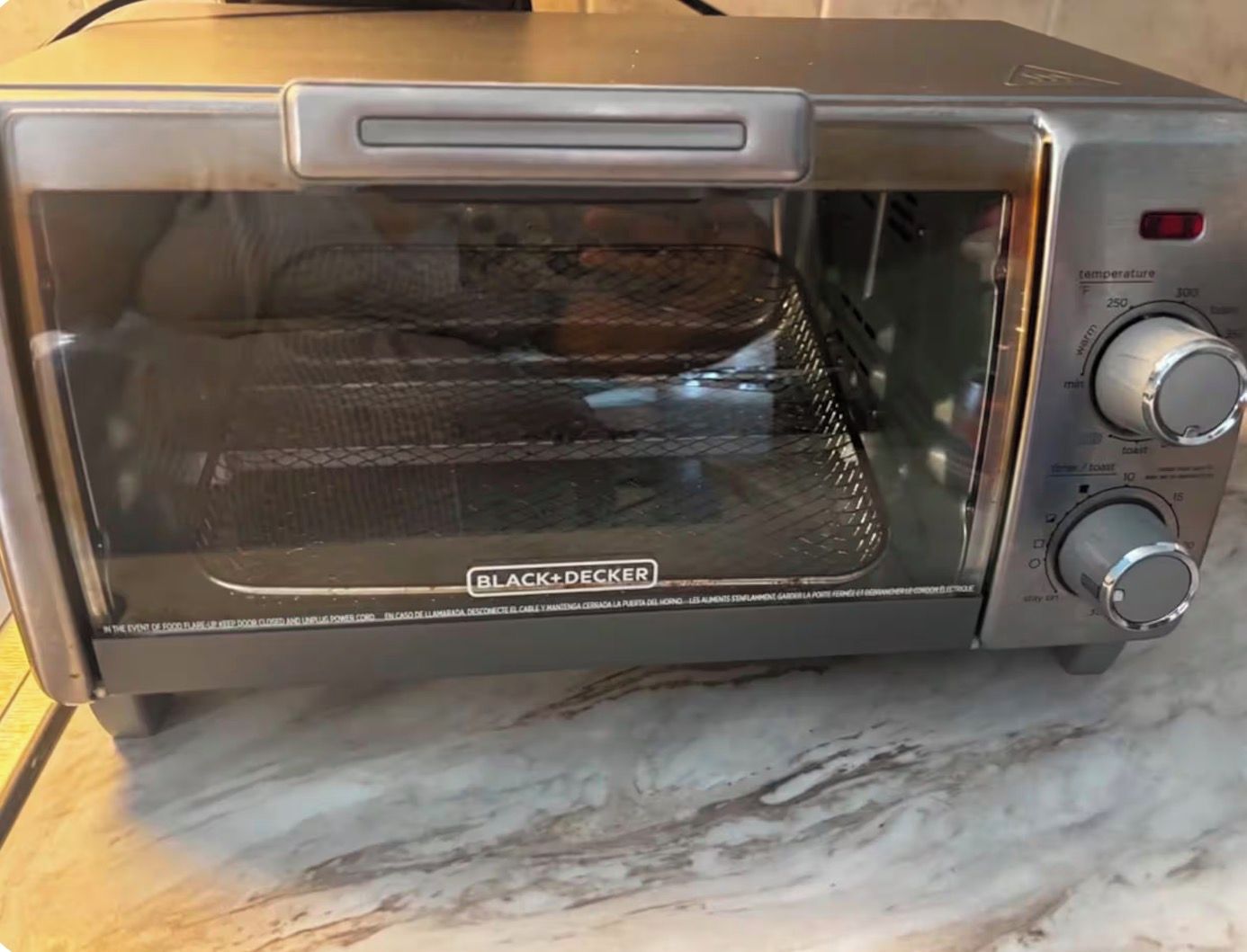 En brödrost från BLACK+DECKER med en digital display och vridknappar för inställning.
