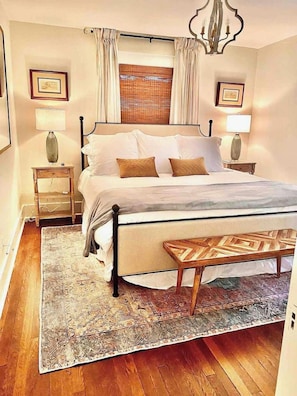 A bedroom with a bed, bedside tables, a bench, a rug, and a window with curtains. - Broadway BNBs III - 1 BR Apartment -Walk to Centre (Danville)