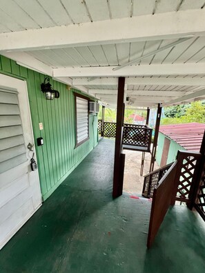 Spacious covered porch with green accents, perfect for a relaxing afternoon - 11BR Coastal Retreat with Pool and Beach Access (Boquerón)