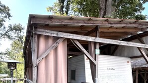 A rustic RV with a covered porch, a bench, and a sign that reads 'Life is better at the lake.' - Anchor’s Rest at Swann’s Marina
Comfort • Hot Tub • Fire Pit • Pet Friendly (Dandridge)