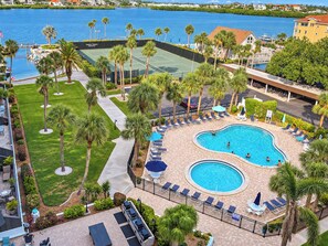 A resort with a large pool, palm trees, and a view of the water. - Renovated + New Furniture, Bayfront Resort Class Amenities, Walk to Siesta Beach (Siesta Key)