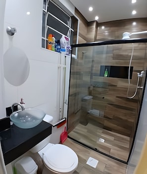 A modern bathroom with a glass shower enclosure, a black countertop sink, and a white toilet. - SHB - Pequeno Paraíso Exclusivo (Santos)
