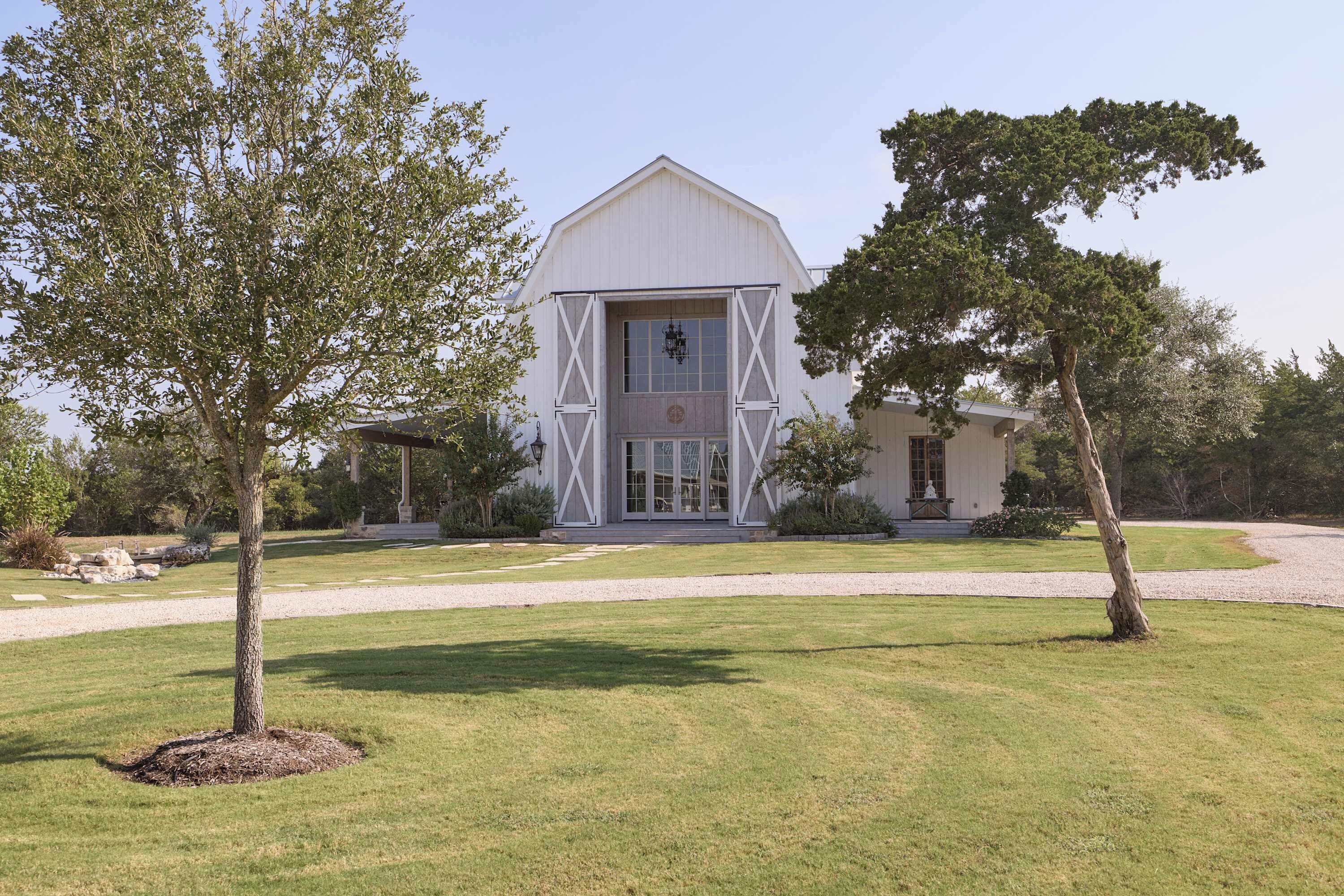 A large white barn-style building with a prominent entrance and a smaller attached structure.