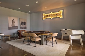 A room with a pool table, bar stools, a foosball table, and wall art. - Hope Ranch | Lux Estate w/ Resort Style Amenities (Round Top)