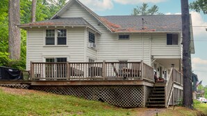 A two-story house with a wooden deck and a small porch. - Pine Hollow Hideout: Access to Canadarago Lake (Richfield Springs)