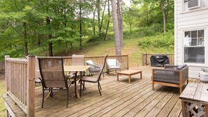 A wooden deck with outdoor furniture including chairs, a table, and a grill. - Pine Hollow Hideout: Access to Canadarago Lake (Richfield Springs)