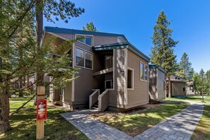 A two-story residential building with a front entrance, a visible mailbox, and a paved driveway. - LLV442 Lake and Mountain Retreat (South Lake Tahoe)