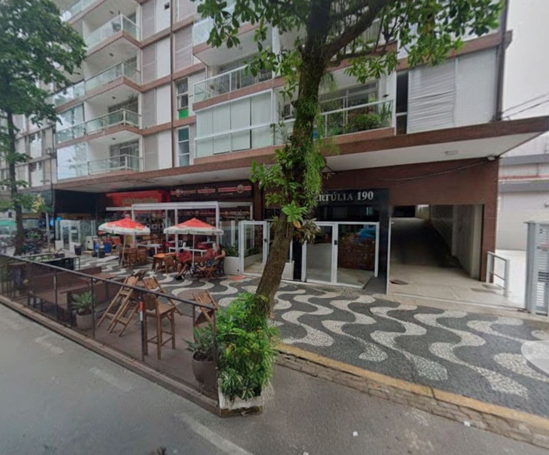 A building with a ground-level cafe and a sign reading "HERTULIA 190".