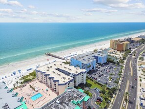A coastal hotel with a beach view, multiple parking lots, and a swimming pool. - Coastal Ocean View Condo at Beach Palms (Indian Shores)