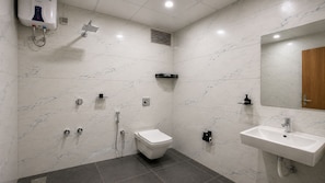 A modern bathroom with a toilet, bidet, shower, and sink. - Hotel Shree Dwarka Devbhumi Dwarka (Dwarka)