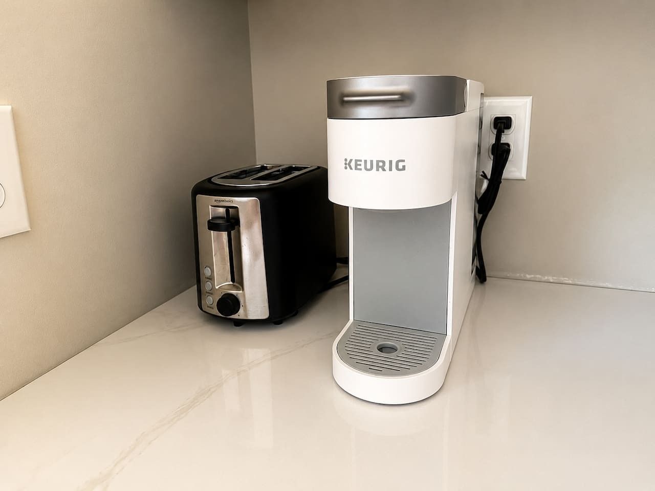Eine KEURIG-Kaffeemaschine und ein Toaster auf einer Arbeitsplatte.