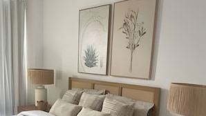 A bedroom with a bed, two bedside tables, and two wall-mounted lamps. - The Penthouse at Vista Alta (Punta Cana)