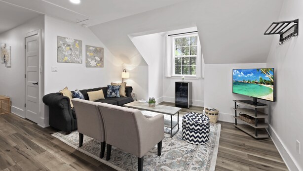 A modern living room with a sofa, coffee table, and a television. - Private 1BR Retreat Among the Pines - Sleeps 4 - Unit 1 (Indian Trail)