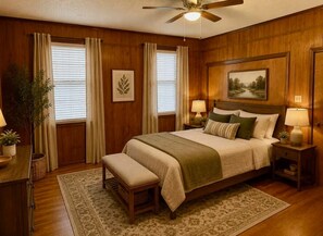 A bedroom with a bed, bedside tables, a bench, a ceiling fan, and a window with curtains. - Cozy Cottage- 5min from Data Center! (Boyce)