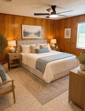 A bedroom with a bed, nightstands, a ceiling fan, and a window. - Cozy Cottage- 5min from Data Center! (Boyce)