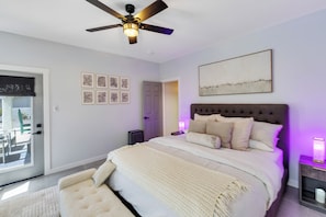 A bedroom with a bed, a ceiling fan, a door, and a window. - Lake Havasu Retreat w Private Pool & Spa, Lake Views + Boat Parking (Lake Havasu City)