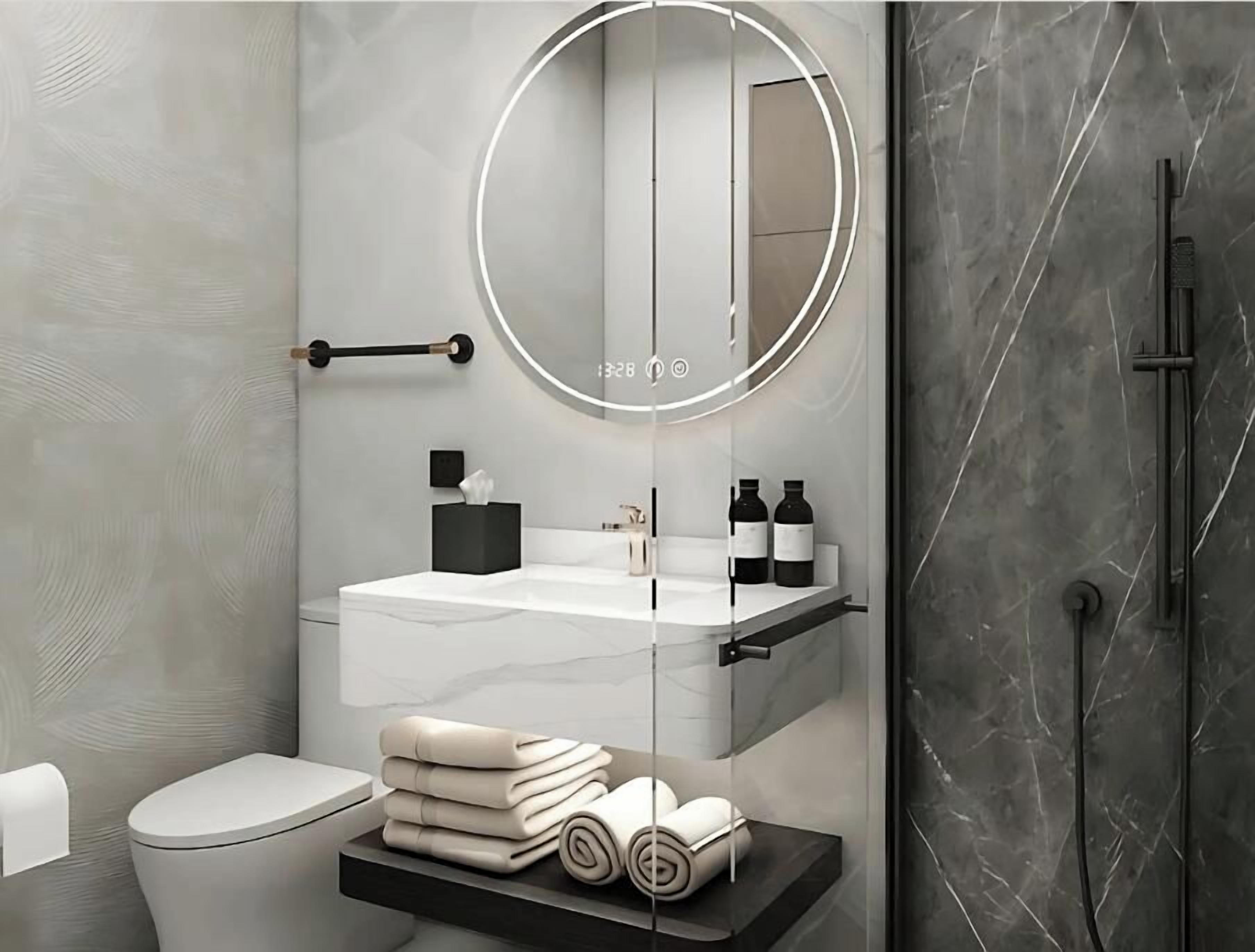 A modern bathroom with a white toilet, a round mirror, a white sink, and a black towel rack.