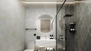A modern bathroom with a toilet, sink, and shower area. - Aura Hotel & Suites  (Mississauga)