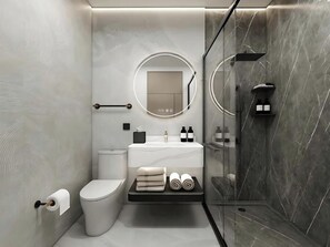 Un baño moderno con inodoro, lavamanos y zona de ducha.