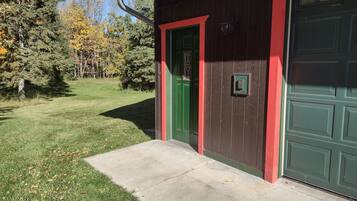 A house with a green door and a garage door.