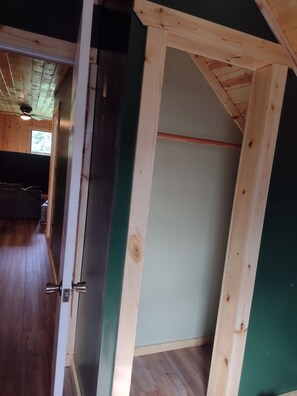 A room with a wooden ceiling, a door with a metal handle, and a visible window. - Welcoming 1-bedroom apartment in charming Squaw Lake (Squaw Lake)