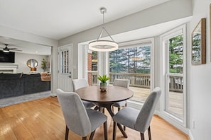 A dining area with a round table, grey chairs, and a hanging light fixture. - Freshly Renovated 4 Bedroom Home In Centerville OH (Dayton)