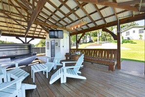 An outdoor covered patio with a grill, seating, and a TV. - Point of View l 3BR - Dock & Big Views (Northport)