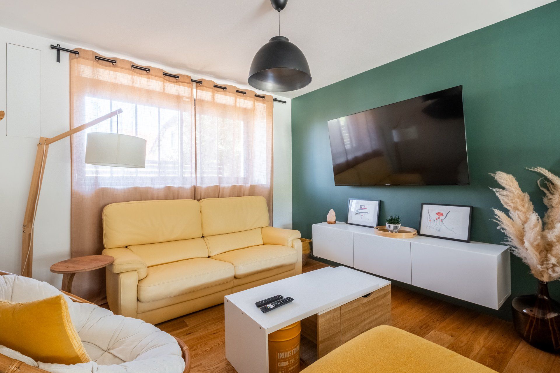 A living room with a sofa, a coffee table, a TV, and a cabinet.