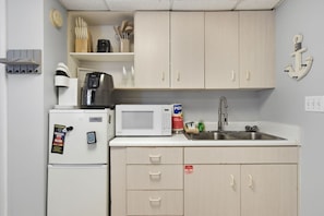 A compact kitchenette with a microwave, coffee maker, and a sink. - Long Beach Resort Beachfront Studio with Ocean View Balcony, Sleeps 4, Tower 1 (Panama City Beach)
