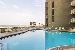 A swimming pool with lounge chairs and a view of the beach. - Long Beach Resort Beachfront Studio with Ocean View Balcony, Sleeps 4, Tower 1 (Panama City Beach)