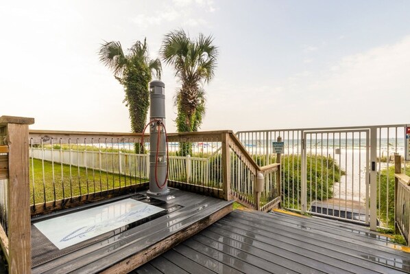 A wooden deck with a metal railing, a water feature, and a view of the beach. - Long Beach Resort Beachfront Studio with Ocean View Balcony, Sleeps 4, Tower 1 (Panama City Beach)