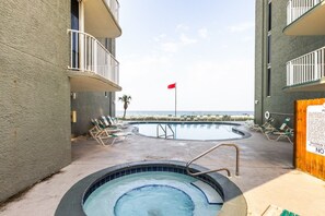 A pool area with lounge chairs and a hot tub, overlooking a beach. - Long Beach Resort Beachfront Studio with Ocean View Balcony, Sleeps 4, Tower 1 (Panama City Beach)