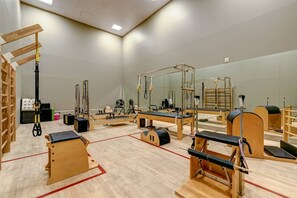 Pilates studio featuring various equipment and wooden fixtures