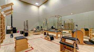 Pilates studio featuring various equipment and wooden fixtures