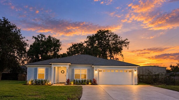 A single-story house with a garage, front porch, and a well-maintained lawn. - New 5BR Home . Walk to Dining . Sleeps 10 (Jacksonville)