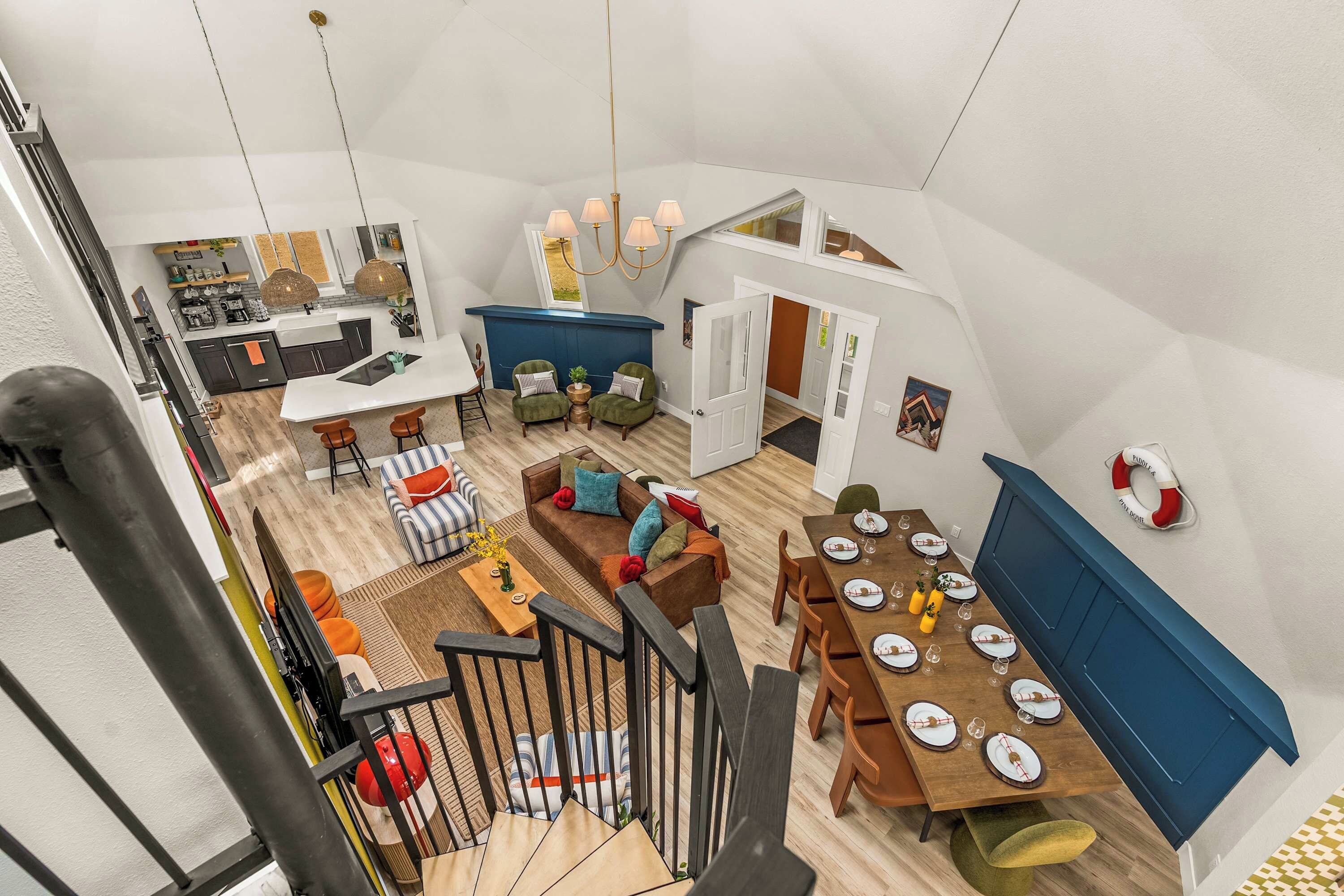 A spacious loft with a kitchen, dining area, and living room.