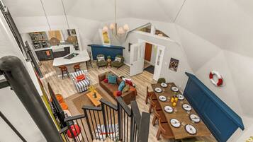 A spacious loft with a kitchen, dining area, and living room.