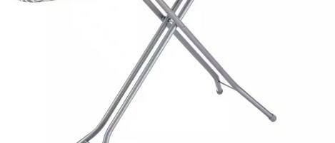 A metallic ironing board with a geometric pattern on the surface.