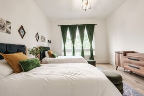 A bedroom with two beds, a dresser, and a window with curtains. - Walk to Coffee and Food - 4 bedroom -2 Car Garage! (Nashville)