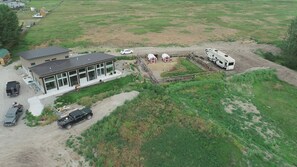 A modern house with a large garage, a covered outdoor area, and a recreational vehicle.