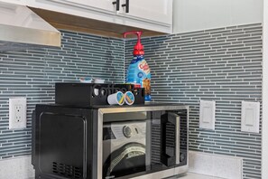A microwave oven with a transparent door, a coffee maker, and a bottle of coffee on top. - Secret Getaway/Sleeps 5/Hot Tub/Secluded/Lake View (Wofford Heights)