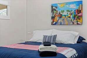A bed with a blue bedspread, white pillows, and a folded blanket. - Secret Getaway/Sleeps 5/Hot Tub/Secluded/Lake View (Wofford Heights)