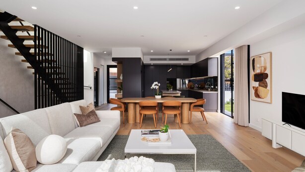 A modern living space with a sofa, coffee table, dining area, kitchen, and staircase. - The Nova - Caulfield South (Caulfield South)