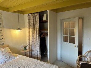 A bedroom with a bed, a bedside table, a hanging light, a wardrobe, and a door. - House with a large yard, perfect for a family vacation. (La Roche-sur-le-Buis)