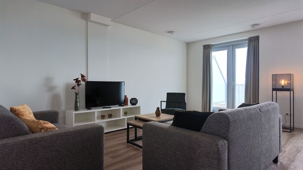 Living area - Modern, fully equipped apartment with a spacious terrace overlooking the Oosterschelde. Suitable for four persons. (Scherpenisse)