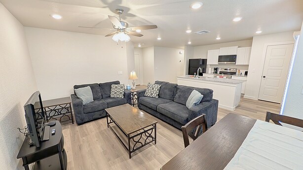 A modern living room with a sofa set, a coffee table, and a TV. - Lubbock Launchpad Retreat (Lubbock)
