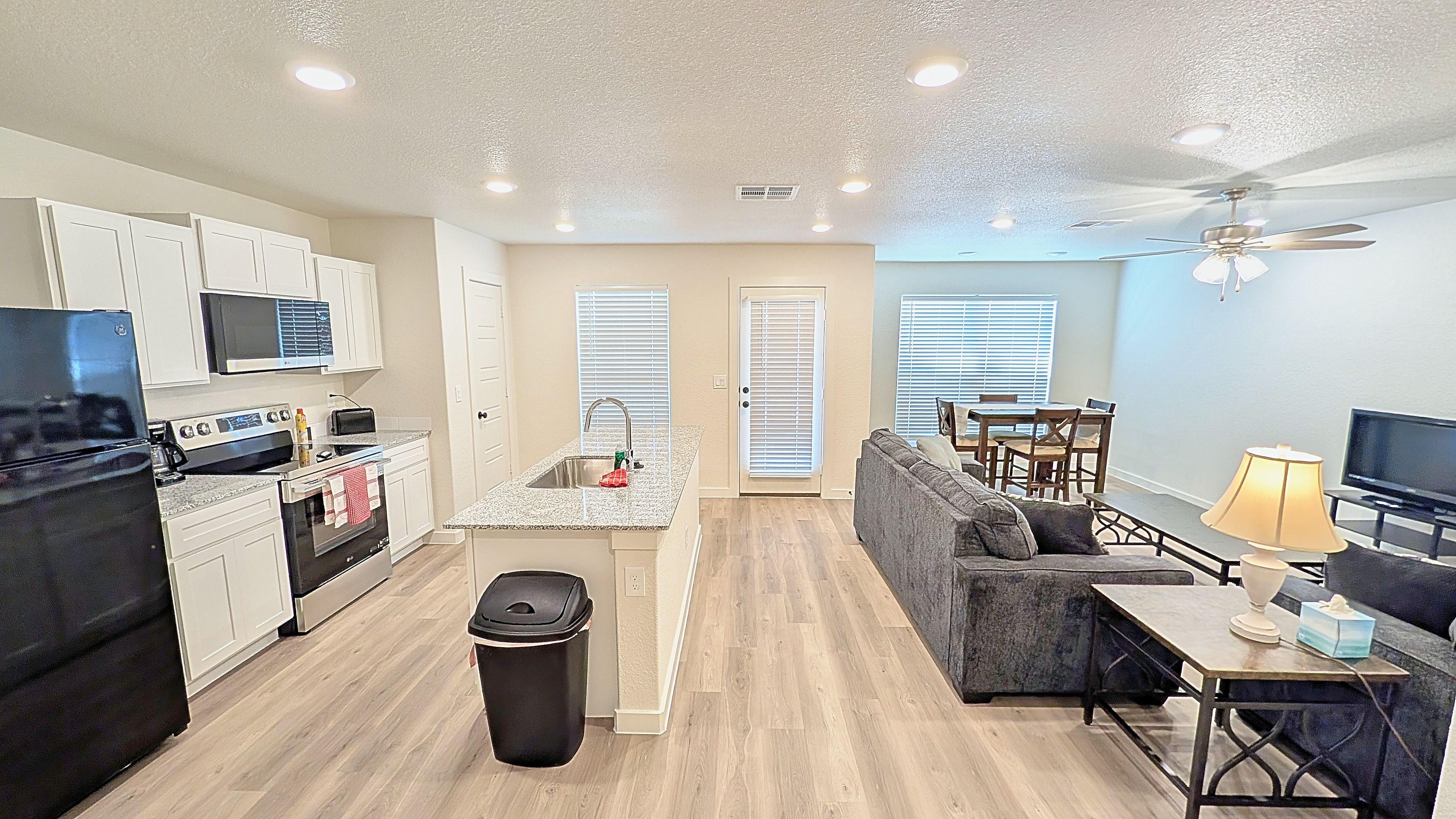 A compact living space with a kitchenette, dining area, and seating area.