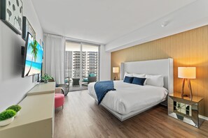 A modern hotel room with a large bed, a desk, a TV, and a balcony with a city view. - ※ Oceanfront Luxury Condo With Water View ※ (Hollywood)