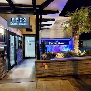 A hotel entrance with a sign for '6508 Knight Street' and 'Sunset Meus' restaurant. - Beautiful Luxury 3 Bed Townhouse (Vancouver)