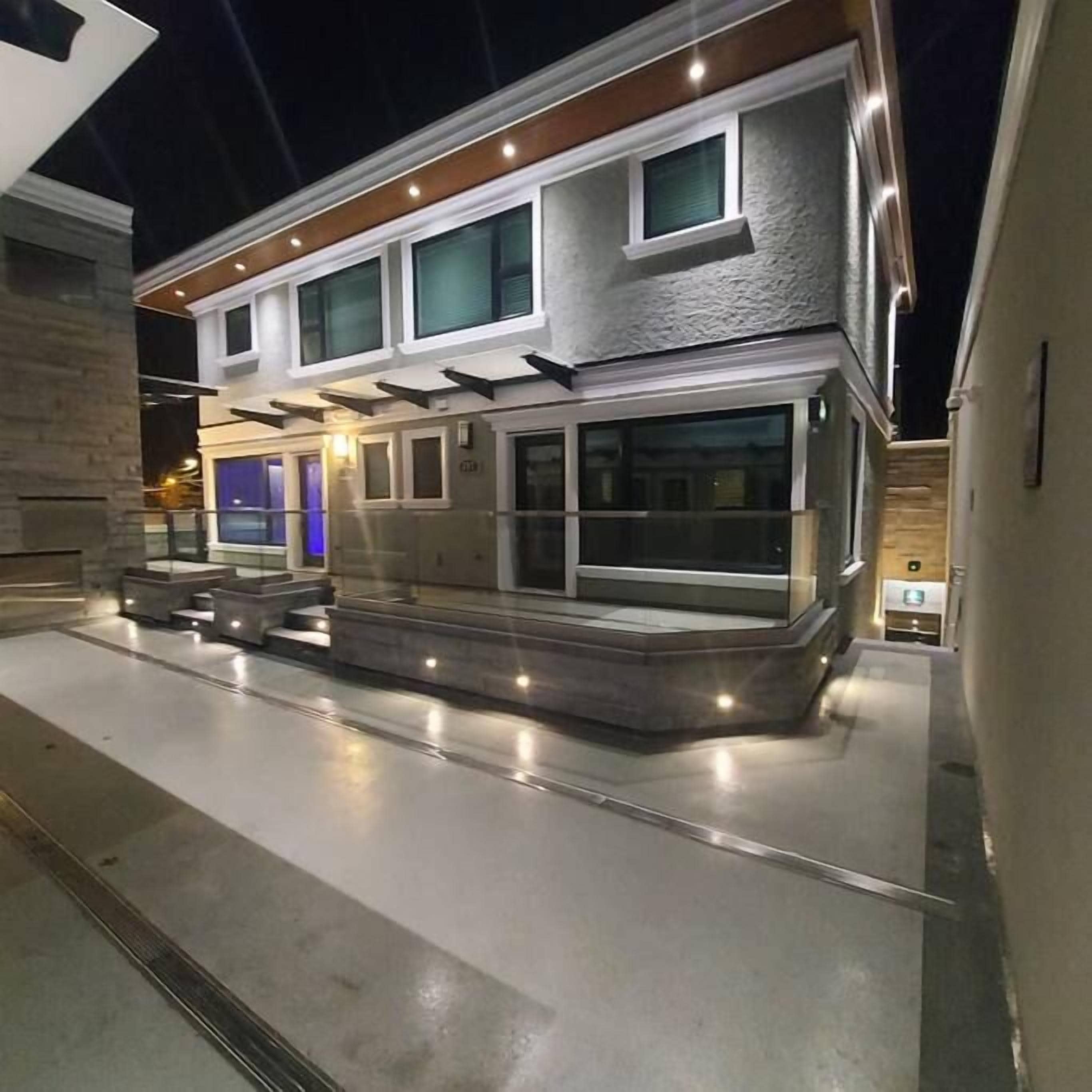 A modern building with a flat roof, large windows, and a central entrance.